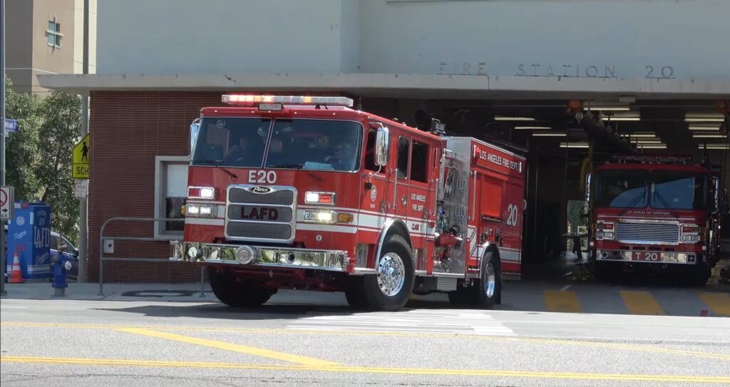 Outside View of Los Angeles Fire Department 20 Echo Park With A Fire Engine And Firefighters Heading Out Of The Station On An Emergency Call