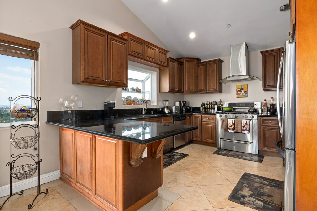 Daytime views of the kitchen with real wood cabinetry and sink area with large bay window and incredible views! El Sereno Hideaway Home For Sale