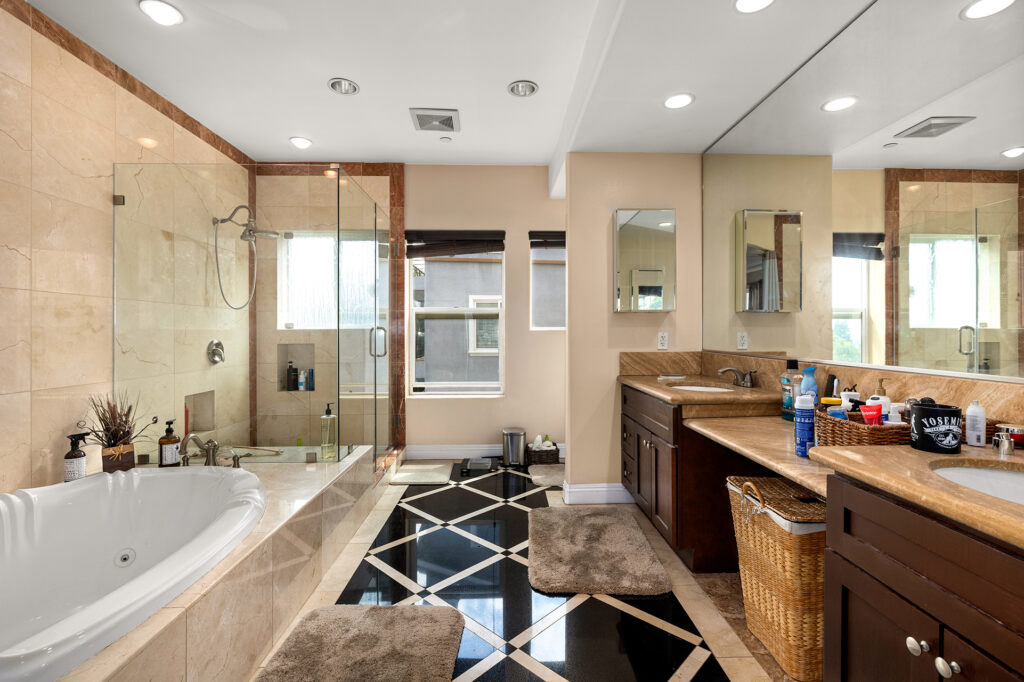 massive bathroom with tub glass wall shower dual vanities. El Sereno Homes for sale