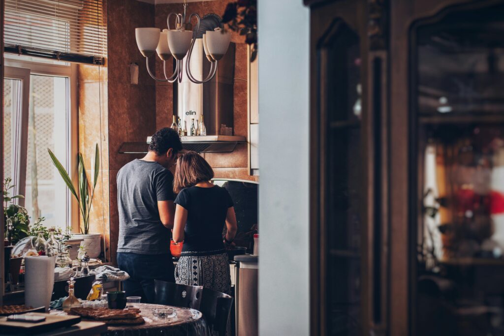 Photo by Soroush Karimi of first time home owners cooking in their kitchen on Unsplash First Time Home Buyers