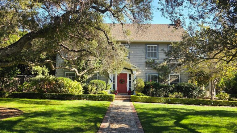 Traditional two story home with a long front walk and green lawn, the kind of house buyers can negotiate on in the 2026 buyer’s market